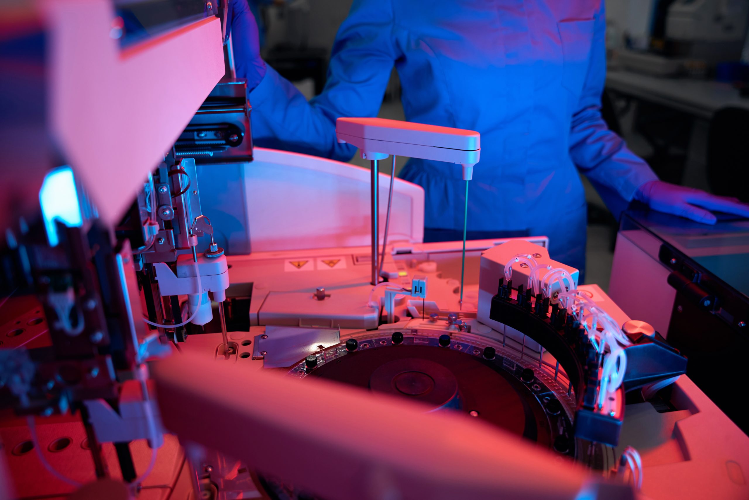Laboratory employee uses a machine for automatic isolation of nucleic acids, the laboratory has modern equipment